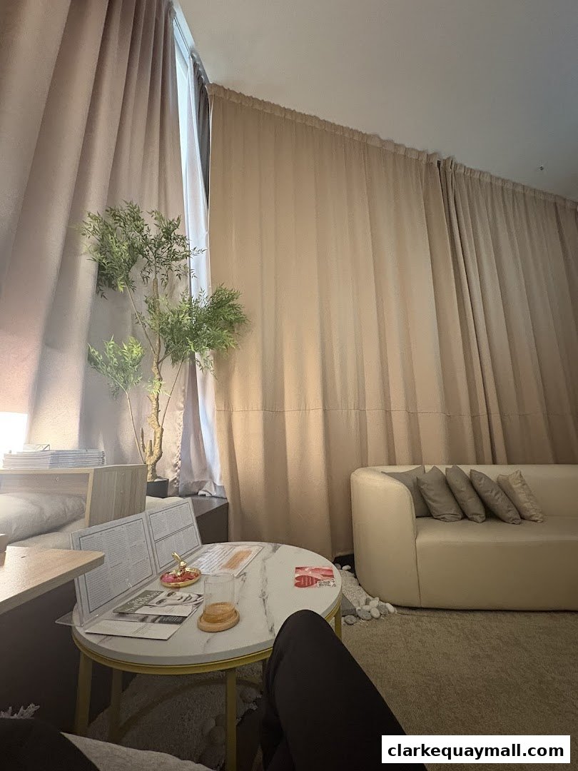 A cozy waiting area with a marble table, sofa, and decorative plant.