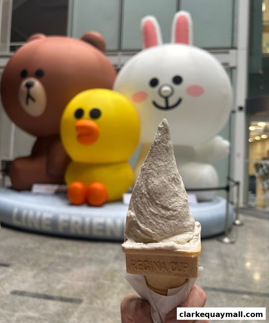 A hand holds an ice cream cone in front of LINE Friends characters.