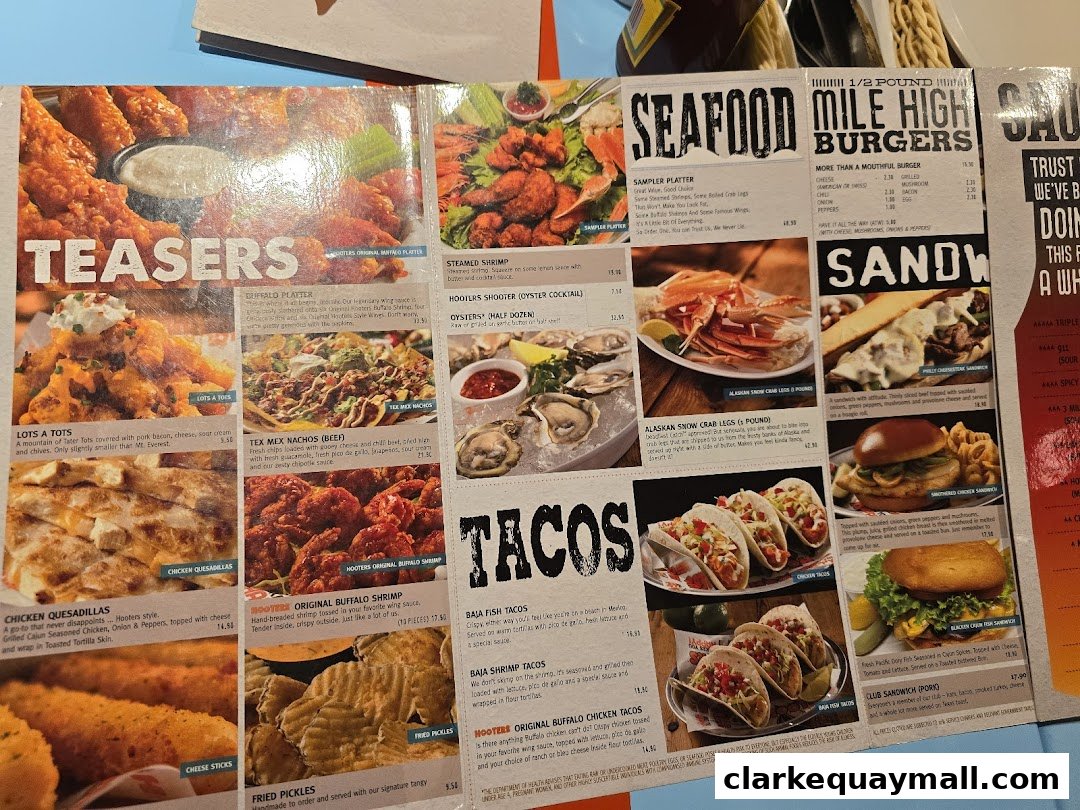 A menu from Hooters featuring appetizers, seafood, burgers, sandwiches, and tacos.
