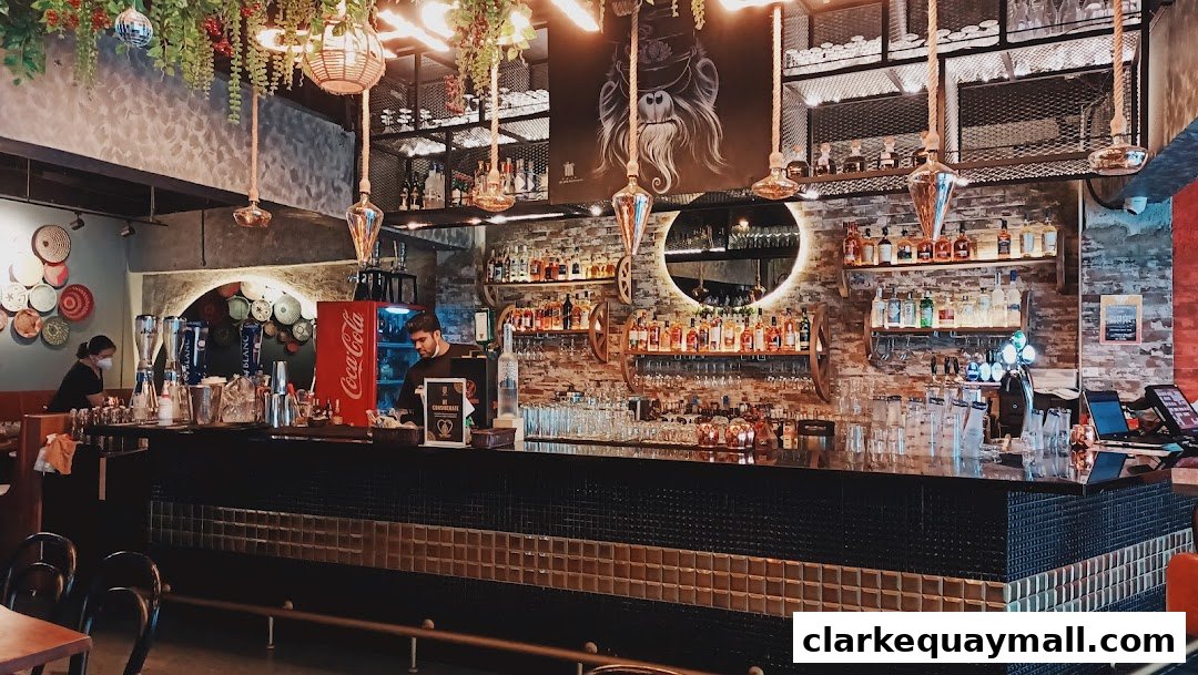 Interior of a stylish bar with a well-stocked liquor shelf and a bartender preparing drinks.