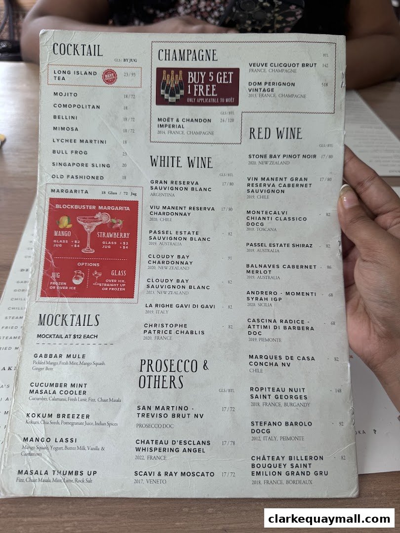 A menu featuring cocktails, champagne, white wine, red wine, and mocktails with prices.