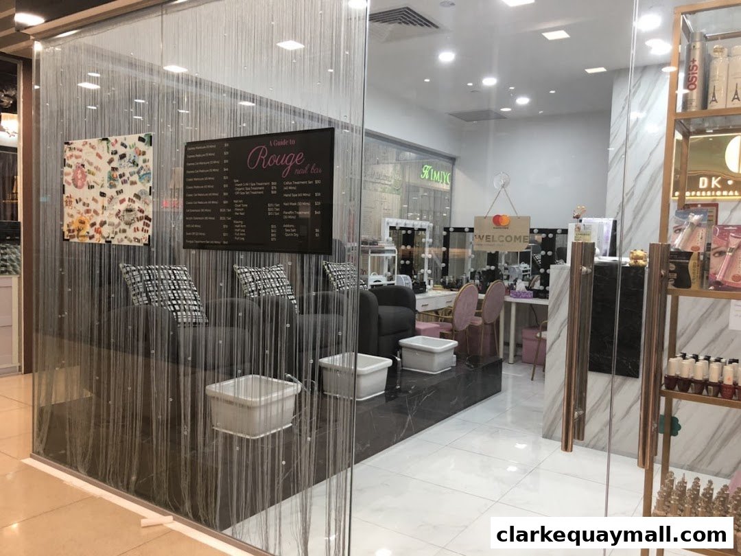 Interior view of Rouge Nail Bar SG, showcasing seating, nail stations, and retail products.