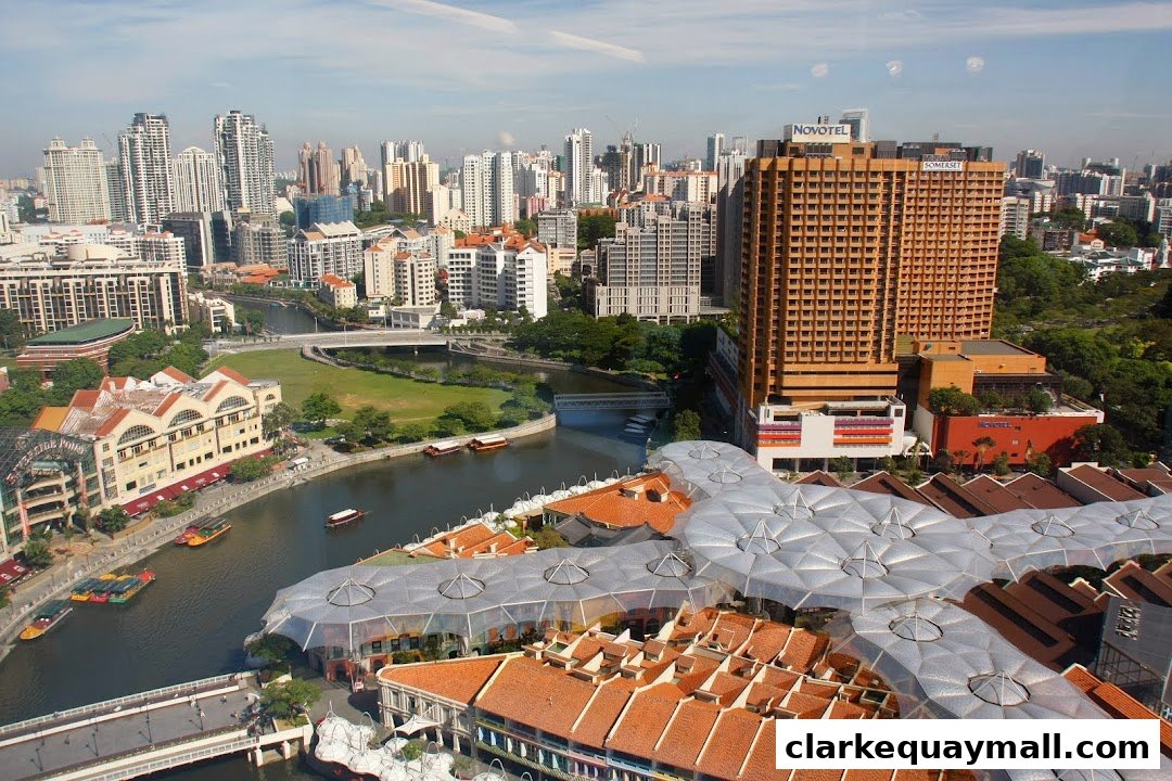 Aerial view of a city skyline with a river and distinctive modern architecture.