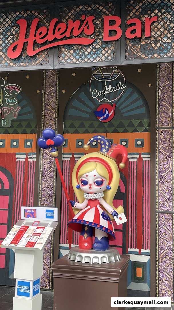 The entrance of Helen's Bar features a striking clown-themed statue and a menu stand.