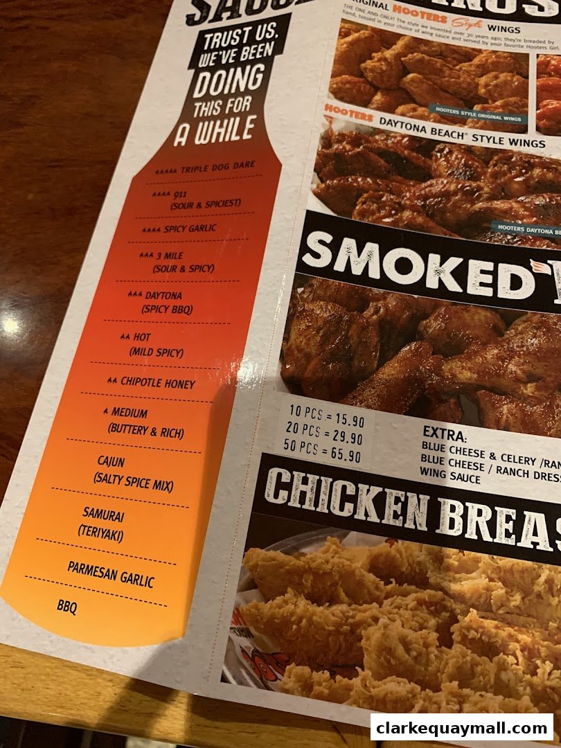 A Hooters menu showcasing various wing sauces and chicken breast options.