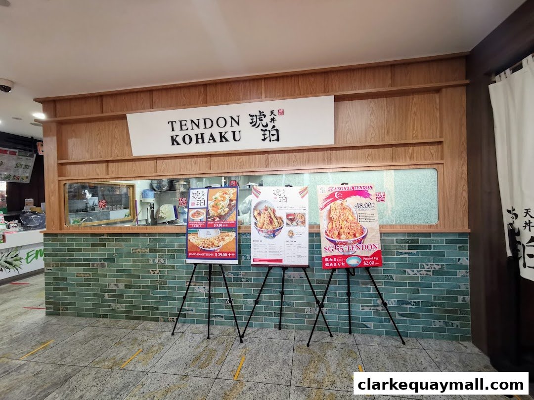 The entrance of Tendon Kohaku, featuring promotional posters and the shop's name.