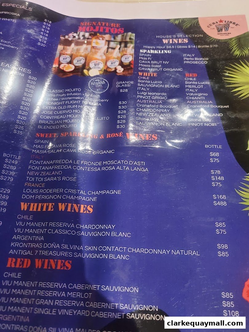 A menu featuring signature mojitos, house selection wines, and various cocktails.