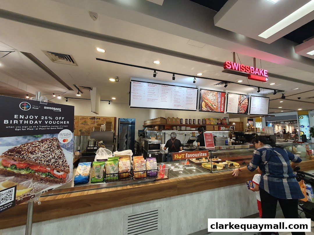 A view of the Swissbake Cafe counter with a promotional poster and customers.