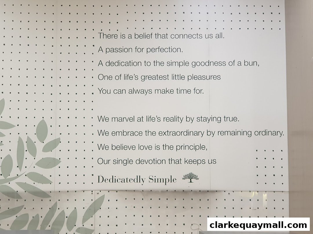A wall display with text about beliefs, passion, and simple pleasures, with decorative leaves.