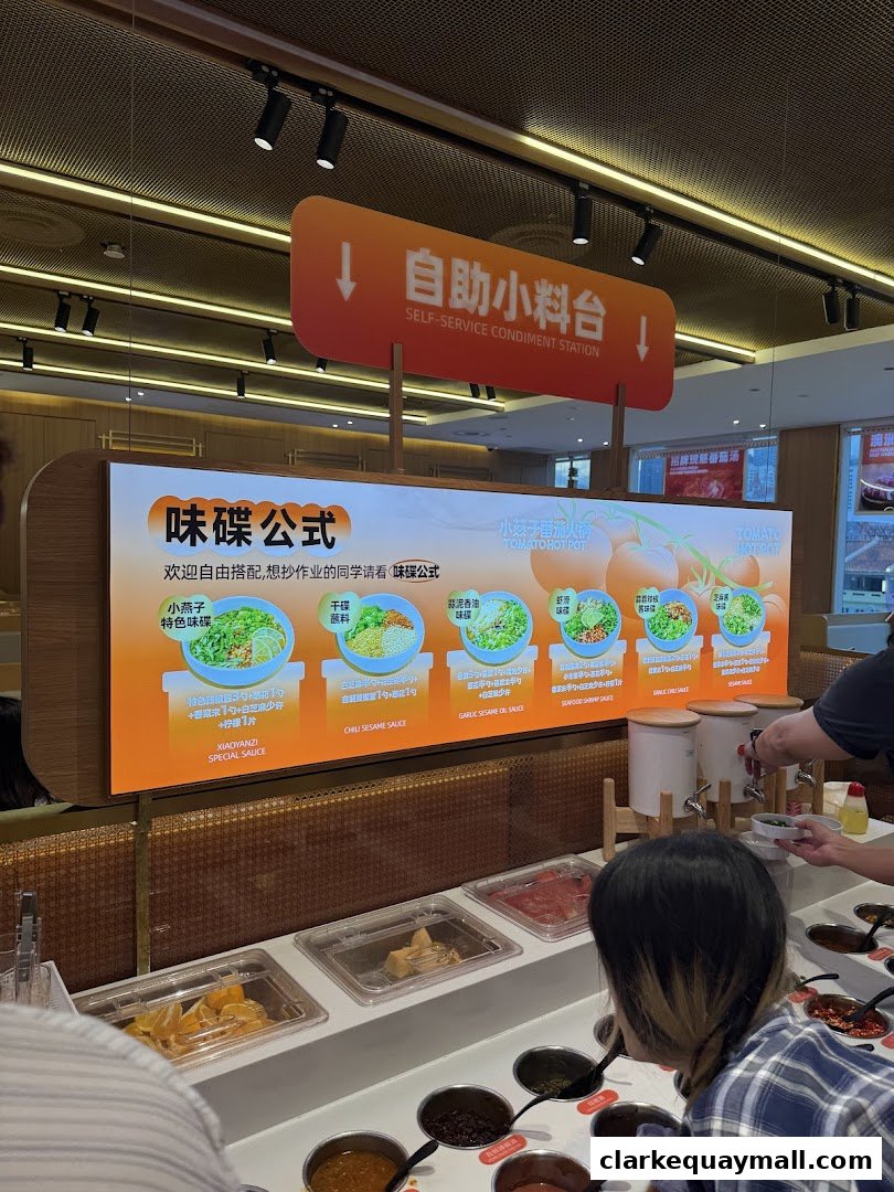 A self-service condiment station at a tomato hot pot restaurant with various sauce ingredients.