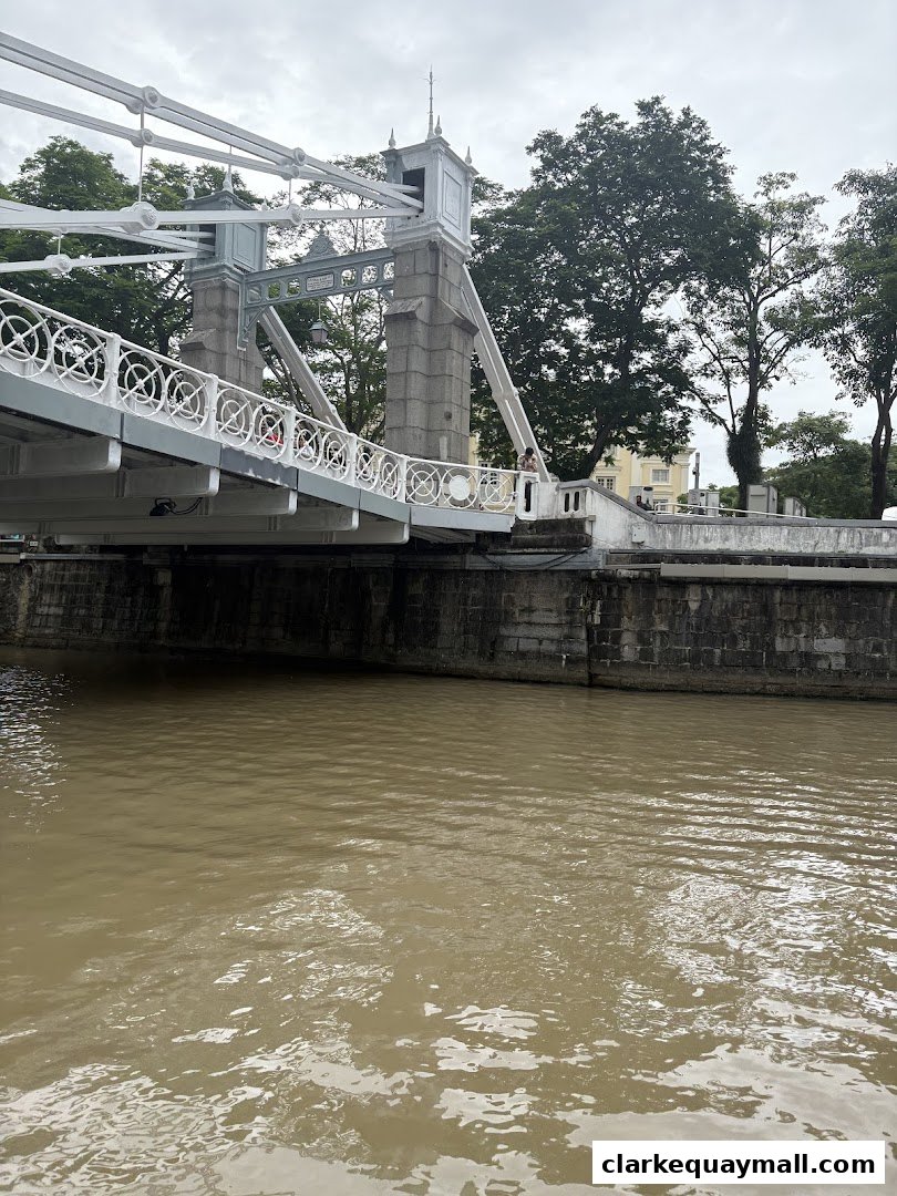 A view of a bridge over a river with trees in the background.