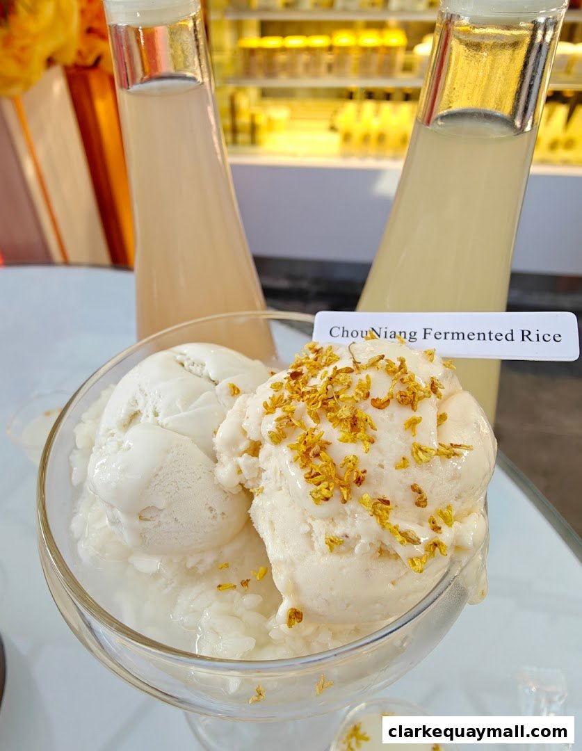 A refreshing dessert featuring ice cream with fermented rice and edible flowers.