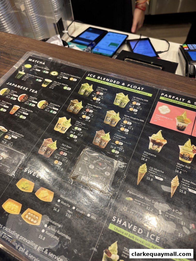 A close-up view of a TSUJIRI menu featuring various matcha and Japanese tea drinks, parfaits, and desserts.