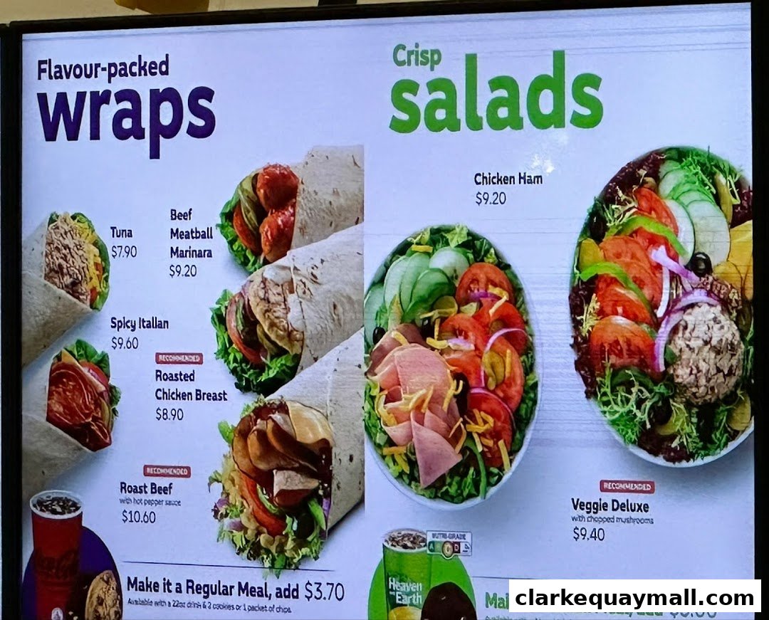 A menu board displaying wraps and salads with prices and images.