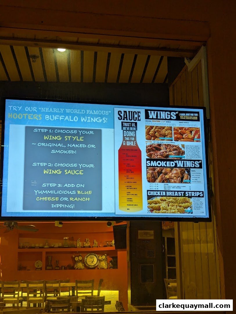A digital menu board displaying Hooters' famous buffalo wings and chicken breast strips.