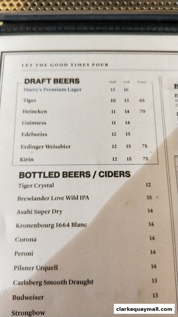 A menu featuring a selection of draft and bottled beers and ciders with prices.