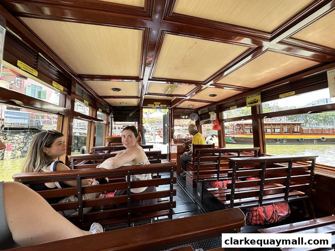 Interior view of a Singapore River Cruise boat with passengers seated and enjoying the view.