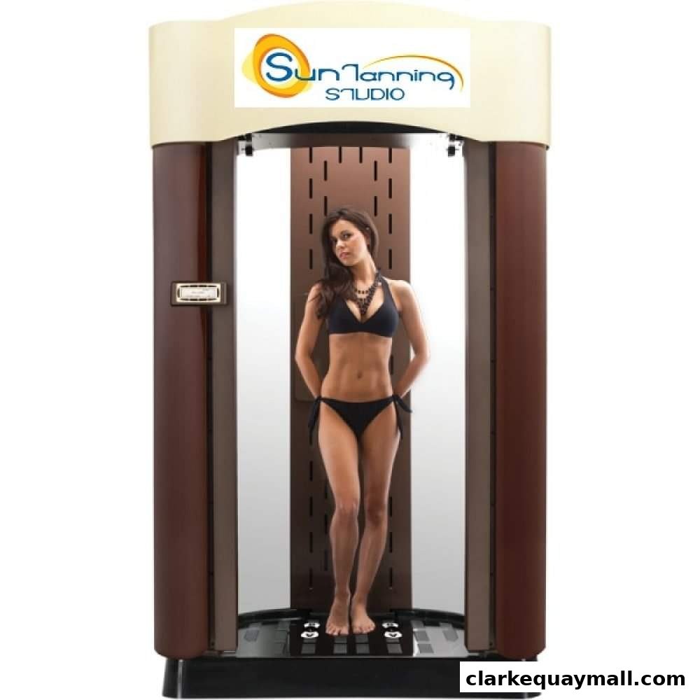 A woman in a bikini stands inside a tanning booth with the Sun Tanning Studio logo.