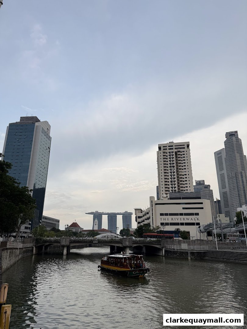 A scenic view of the Singapore River with a boat and city skyline.