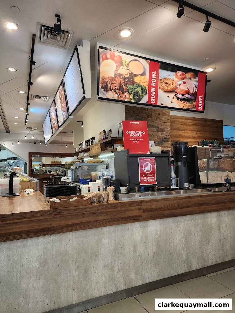 Interior view of Swissbake Cafe counter with digital menus and food displays.