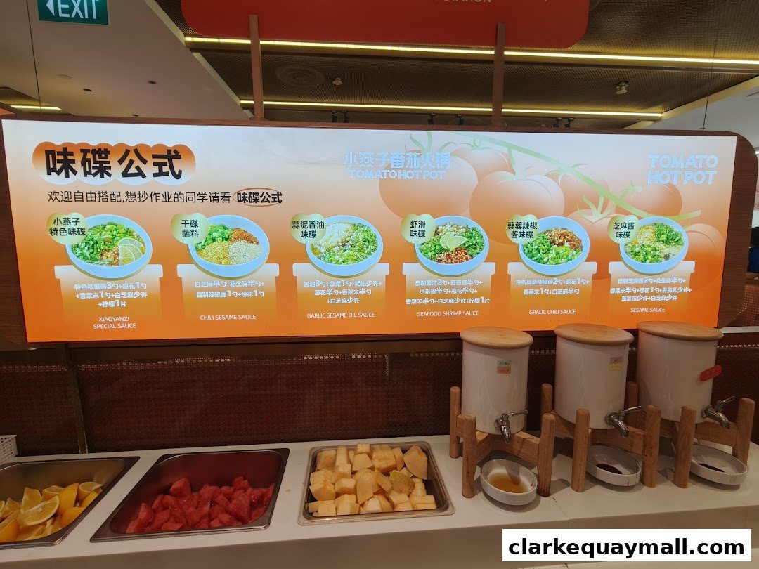 A display of various sauces and fresh ingredients for hot pot at XiaoYanZi Tomato Hot Pot.