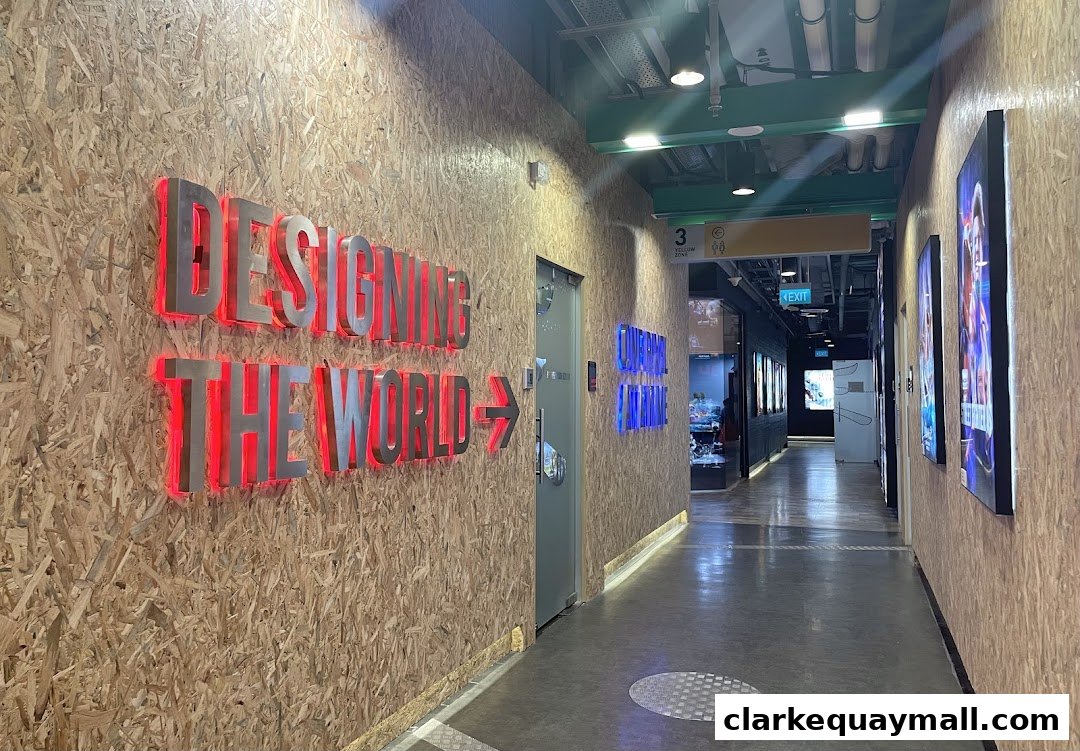 A hallway with a sign that says 'DESIGNING THE WORLD' and illuminated posters on the wall.