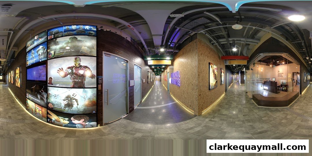 A wide-angle view of a modern hallway with digital displays and shop entrances.