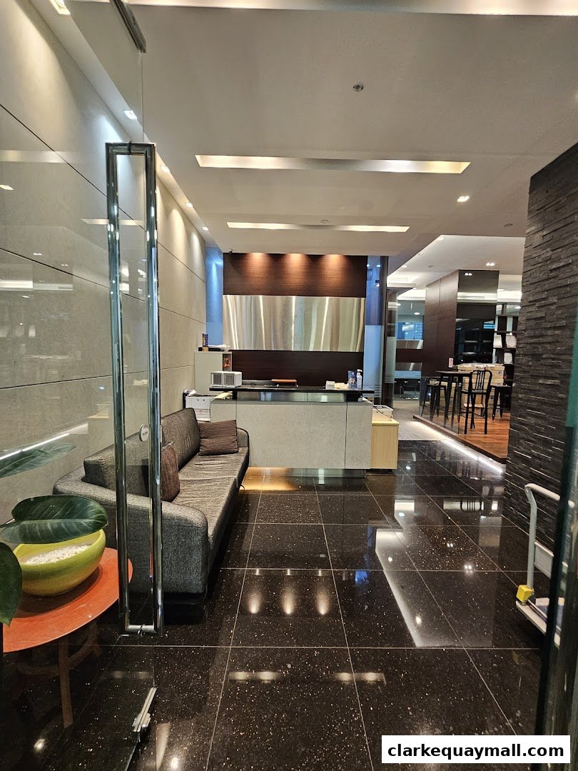 Interior view of a modern reception area with a sofa, reception desk, and seating area.