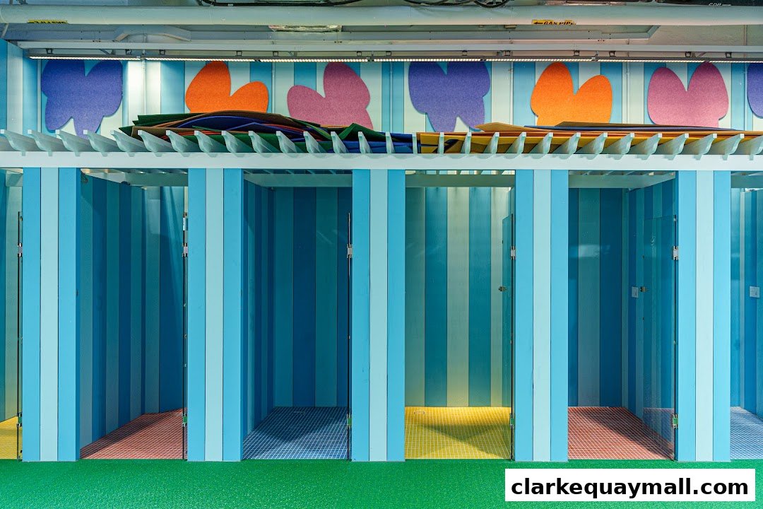Colorful changing rooms with striped walls and patterned floors, featuring felt shapes on the wall.