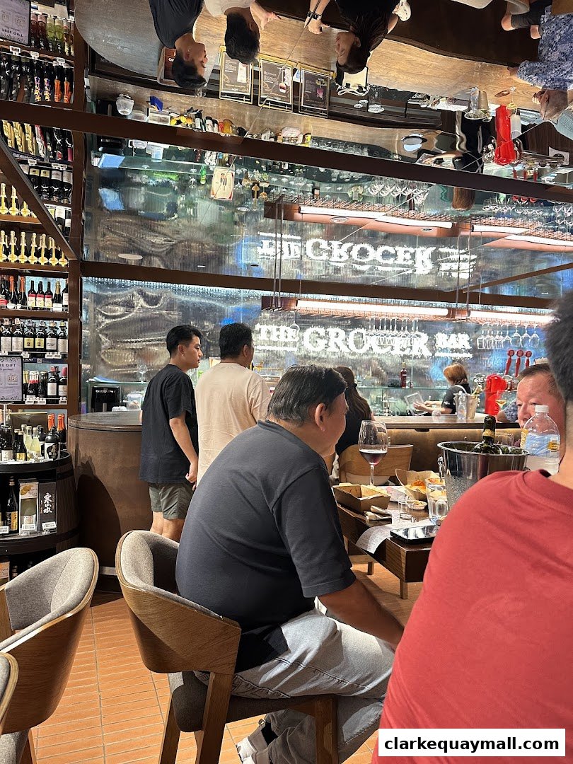 People dining and shopping at a well-stocked grocery store with a bar area.