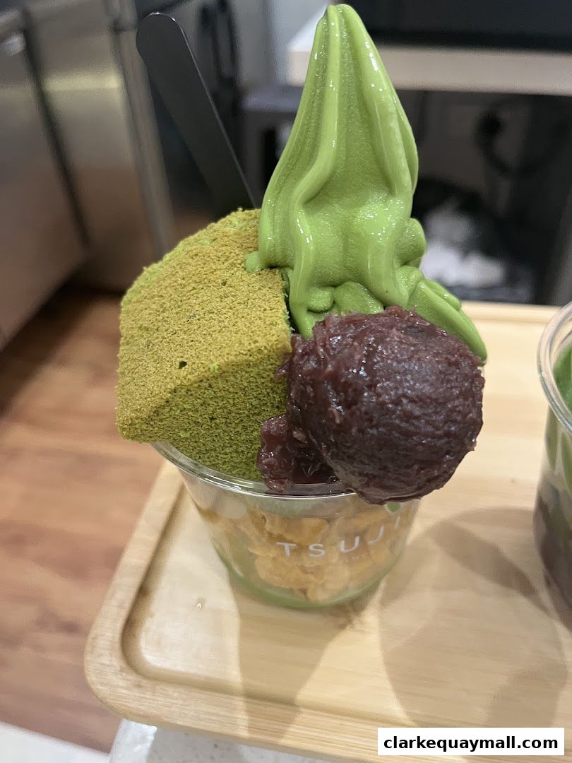 A delicious matcha dessert with soft serve ice cream, red bean paste, and cake.