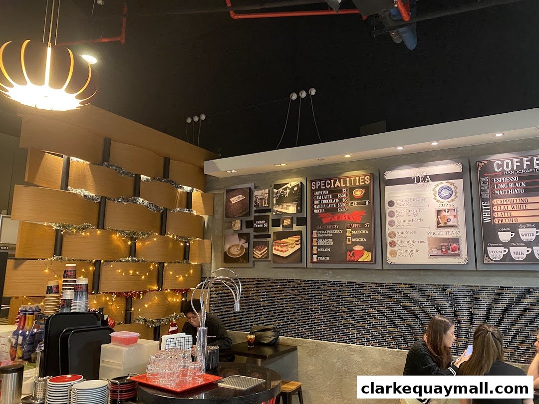 Interior of a cafe with menus displaying coffee, tea, and specialty drinks.