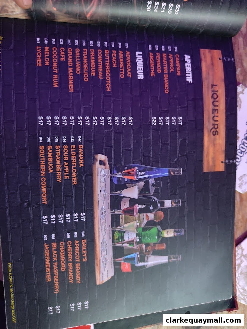 A menu page displaying various liqueurs and aperitifs with prices, alongside a display of bottled drinks.