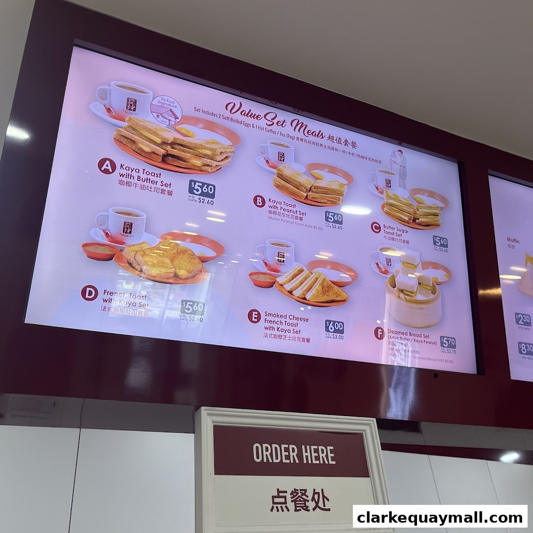A digital menu board displaying various value set meals from Ya Kun Kaya Toast.
