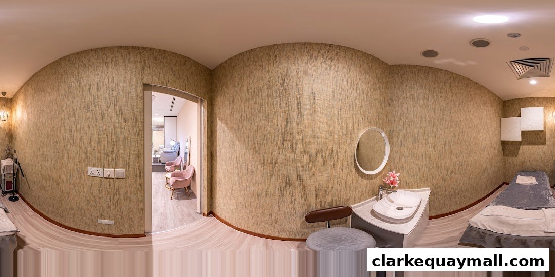 Interior view of a beauty salon with treatment beds, a sink, and seating area.