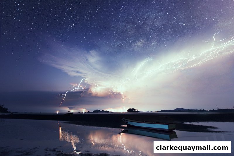 A dramatic night sky with lightning strikes over a calm body of water and a boat.