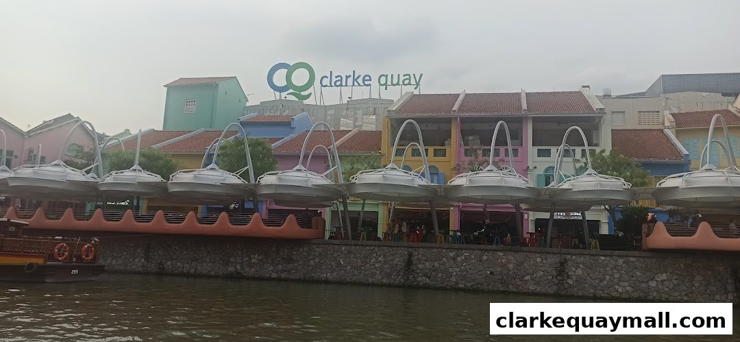 A scenic view of colorful buildings along a river with unique overhead structures.