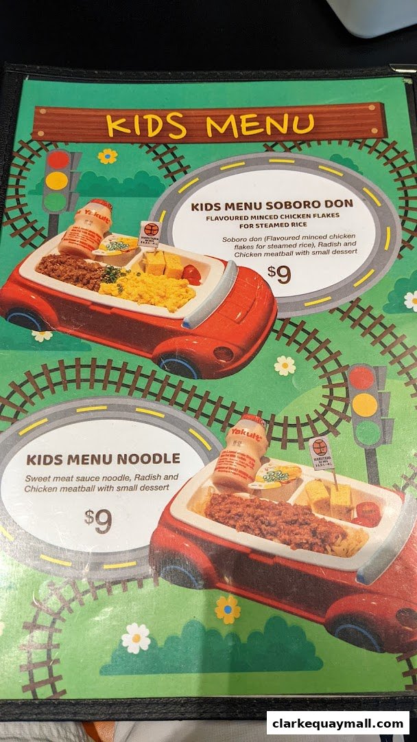 A kids' menu from Marutama Ramen featuring two meal options presented in car-shaped trays.