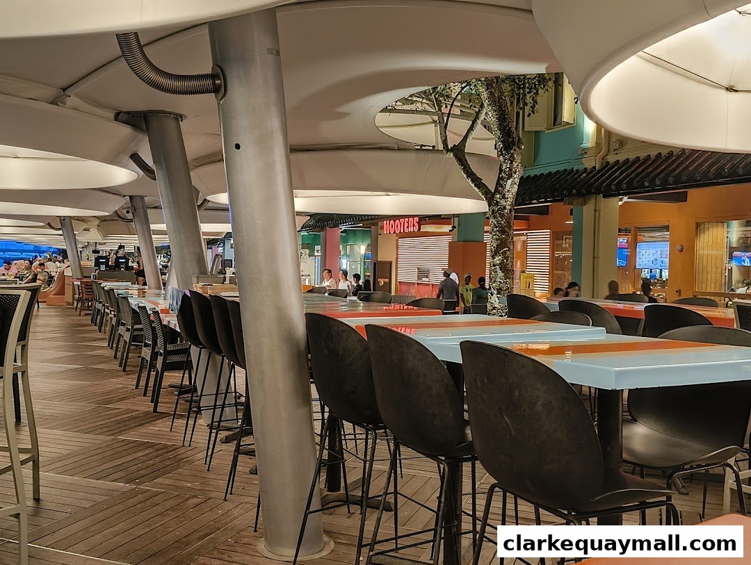 Outdoor seating area with tables and chairs at Hooters restaurant.