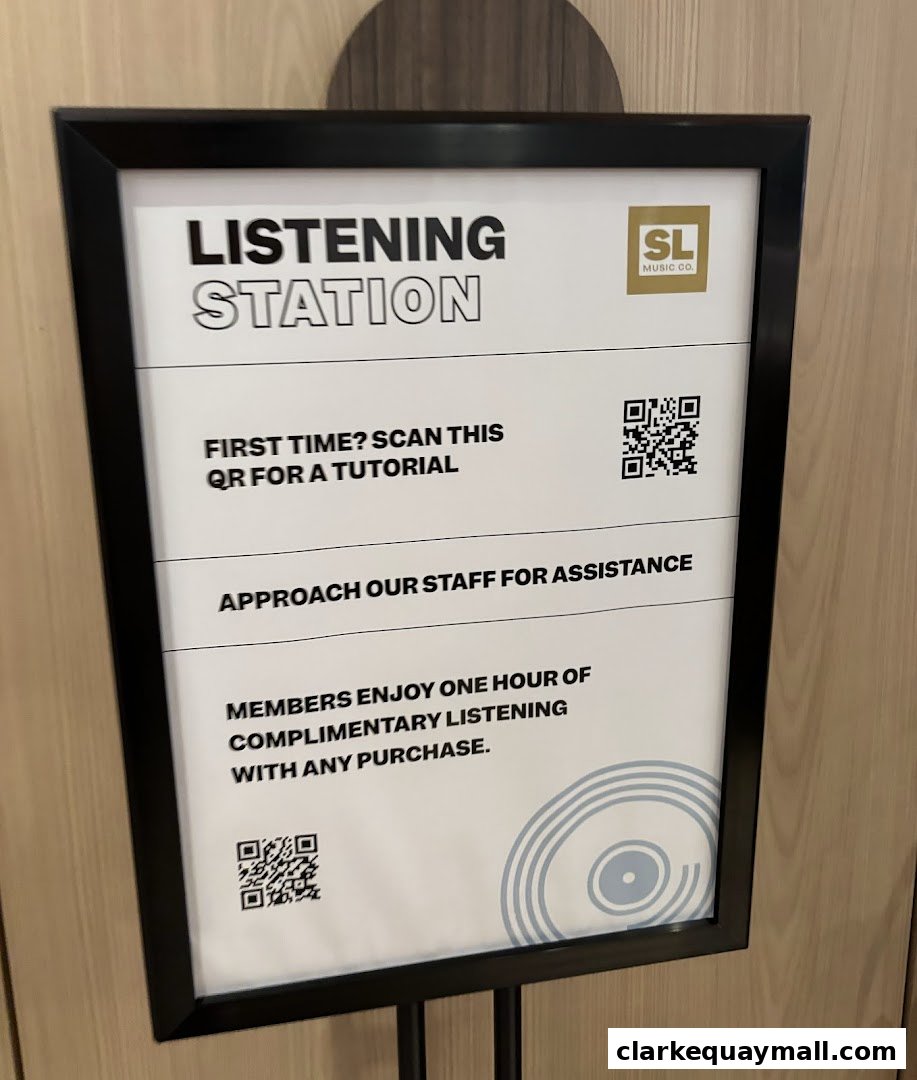 A sign for a listening station at SL Music Co. offering a tutorial and complimentary listening.