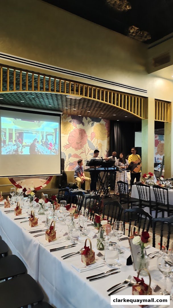 A band performs at a formal event with long tables set for dining.