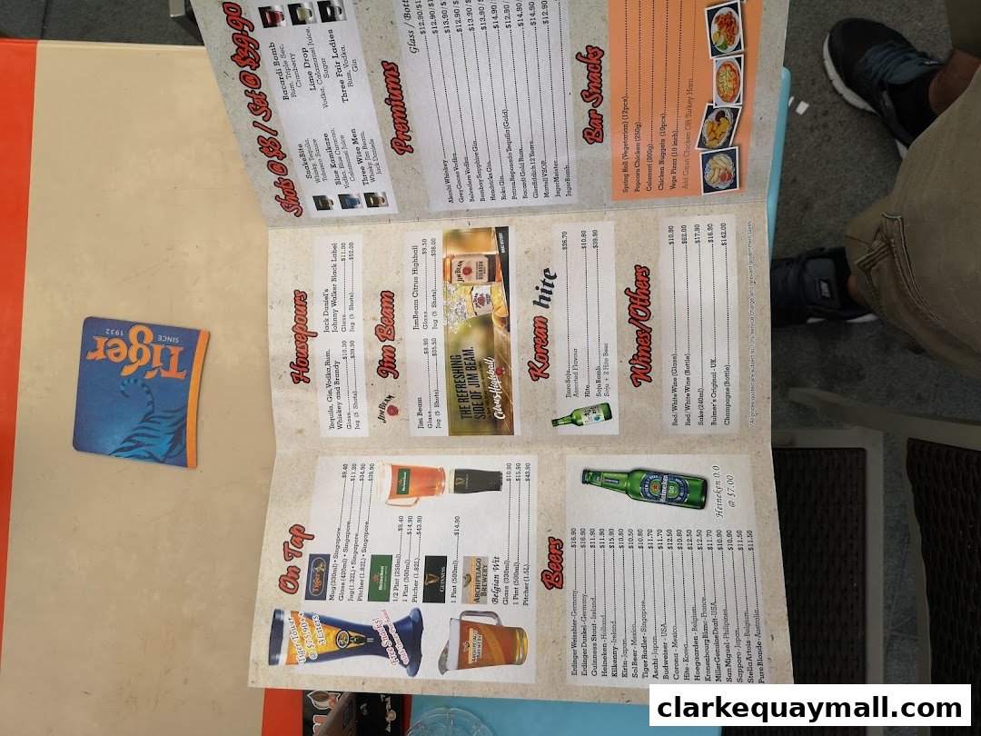 A menu from Hooters featuring drinks and bar snacks, with a Tiger beer coaster.