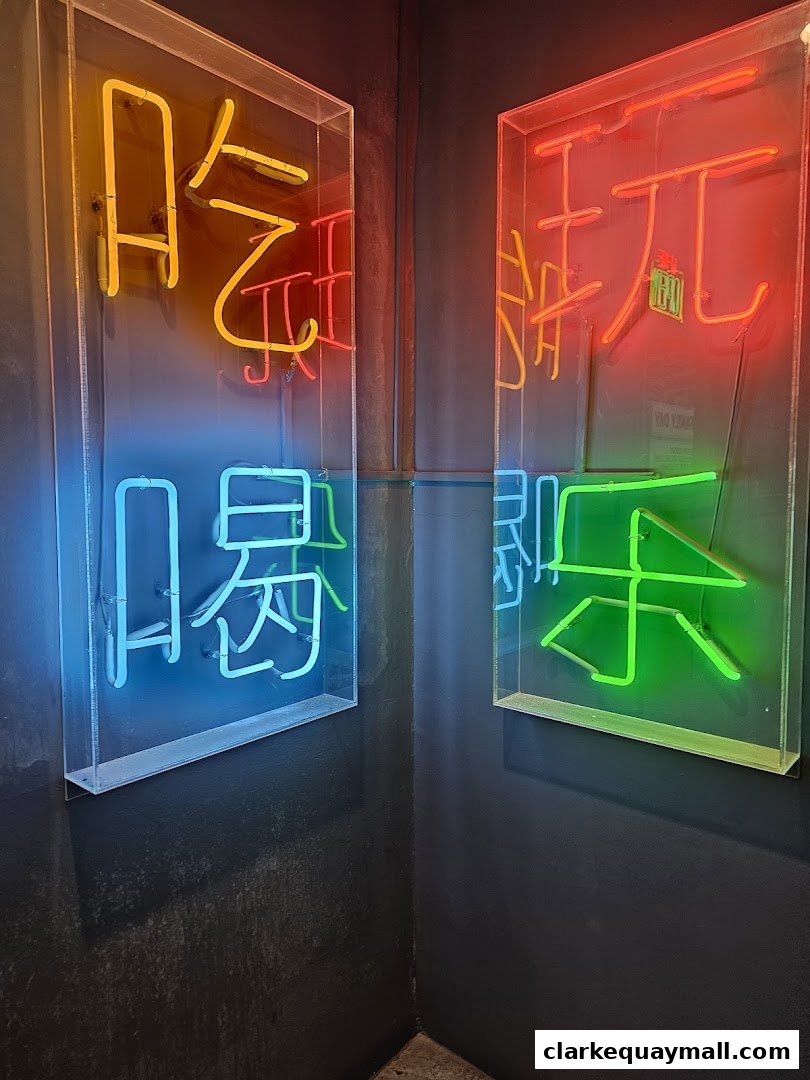 Neon signs in Chinese characters illuminate a dark corner of a bar.