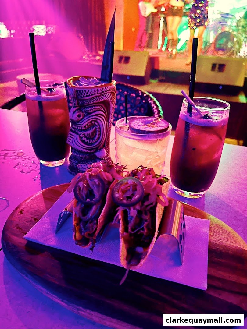 Tacos and tropical cocktails served with a live band performing in the background.