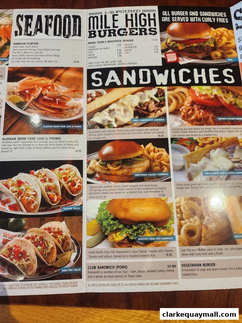A menu from Hooters featuring seafood, burgers, sandwiches, and tacos.