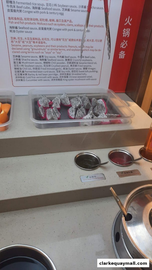 A display of fresh dragon fruit slices and other ingredients for hot pot.