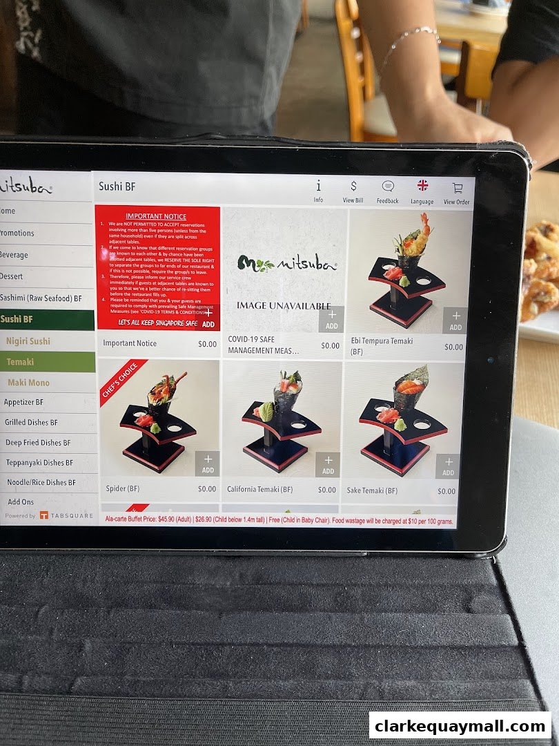 A tablet displays the Mitsuba Japanese Restaurant menu with various sushi and temaki options.