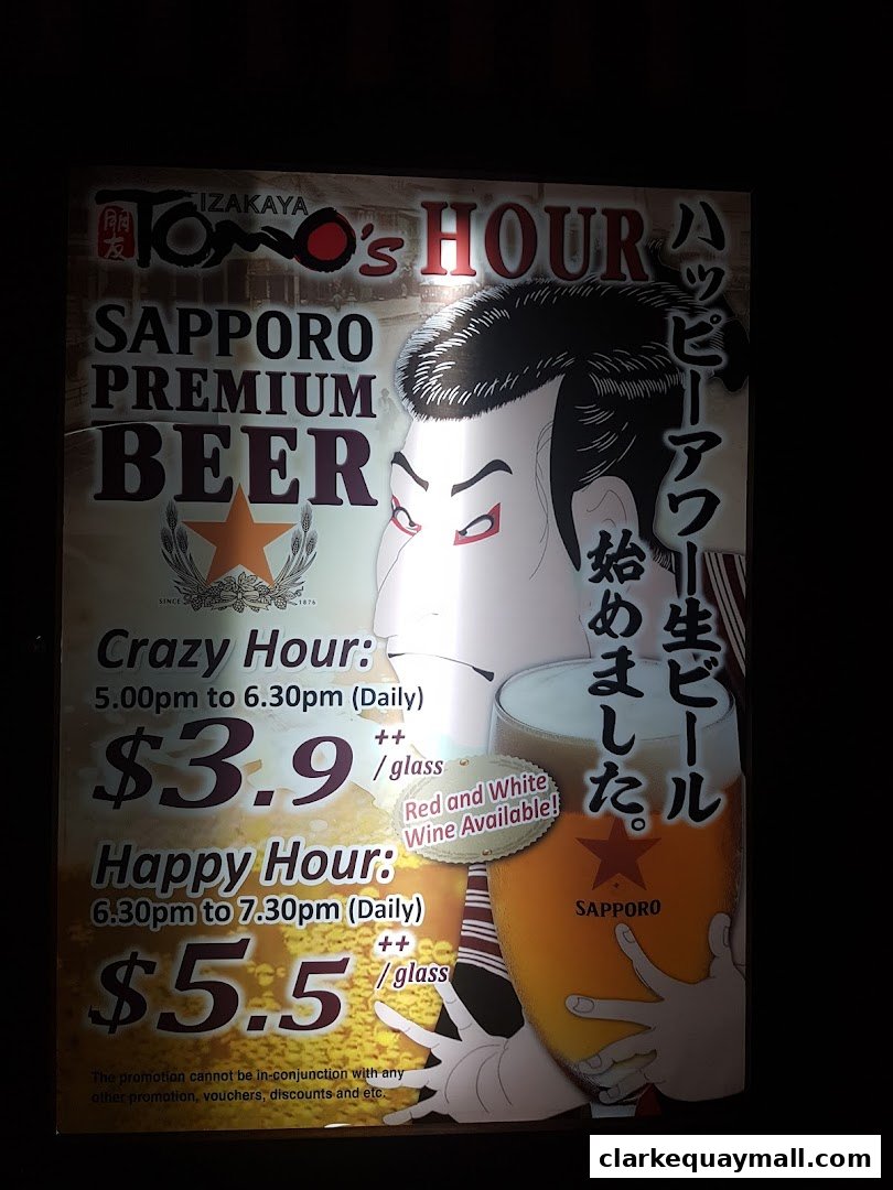 A sign advertising Sapporo Premium Beer happy hour deals at Tomo Tokyo Izakaya.