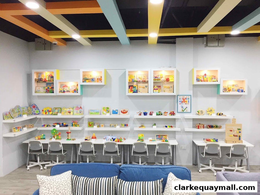Interior of a bright toy store with shelves displaying various educational toys and play areas.