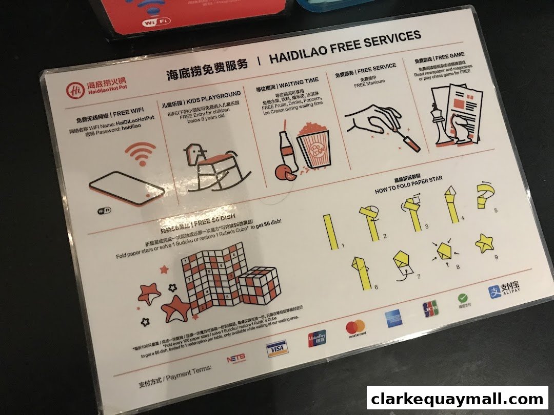 A sign detailing Haidilao's free services including WiFi, kids' playground, waiting time snacks, manicures, and games.